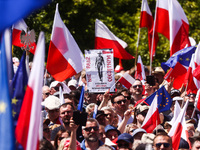 Participants attend an anti-government march led by the opposition party leader Donald Tusk on the 34th anniversary of Poland's first postwa...