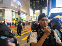 

A police officer is talking on a walkie talkie in Causeway Bay, Hong Kong, China, on June 4, 2023. (