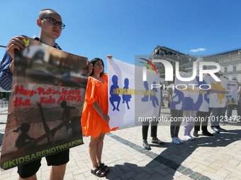 Ukrainians hold placards during an event dedicated to the Day of remembrance of children who died as a result of the armed aggression of Rus...