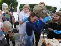 Kids wear gas masks during an event dedicated to the Day of remembrance of children who died as a result of the armed aggression of Russia a...