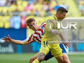 Alberto Moreno (R) of Villarreal CF competes for the ball with Barrios of Club Atletico de Madrid during the LaLiga Santander match between...