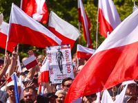 Polish flags and banners are seen during an anti-government 'Freedom March' on the 34th anniversary of Poland's first postwar democratic ele...
