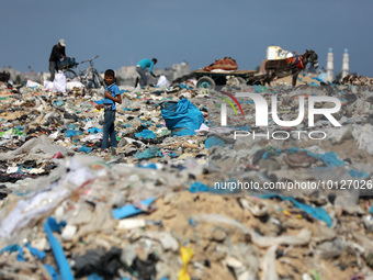 Palestinians collect plastic from a waste dump in Beit Lahia in the northern Gaza Strip, on June 5, 2023. June 5th is World Environment Day...