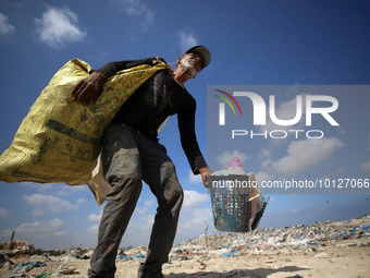 A Palestinian collects plastic from a waste dump in Beit Lahia in the northern Gaza Strip, on June 5, 2023. June 5th is World Environment Da...