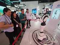 BEIJING, CHINA - JUNE 5, 2023 - Visitors interact with a ''5G intelligent robot'' at the 31st China International ICT Exhibition in Beijing,...