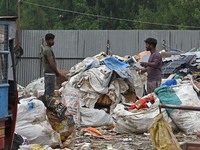 Scrap collectors work at an open air storage area for plastic waste on the World Environment Day in Srinagar, Kashmir on June 05, 2023. In I...