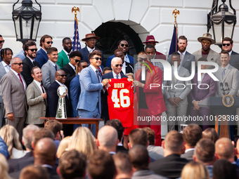 Kansas City Chiefs Patrick Mahomes and Travis Kelce present President Joe Biden with a personalized jersey during an event celebrating the t...
