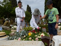 TEL AVIV, ISRAEL - MAY 05: Israelis place flowers on the grave of a fallen Israeli soldier at the military cemetery Kiryat Shaul on May 5, 2...