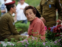 TEL AVIV, ISRAEL - MAY 05: An Israeli elder woman sits by the grave of a fallen Israeli soldier at the military cemetery Kiryat Shaul on May...