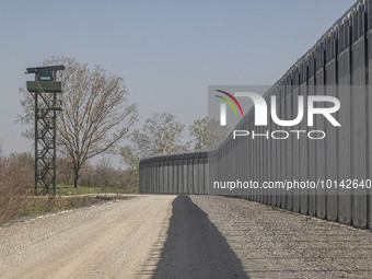 The fortification fence with a watch tower post in the background for border police and the military equipped with camera and surveillance g...