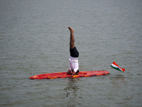 A participant performs yoga on the surface Yamuna River to mark the International Yoga Day celebrations on June 21, 2023 in New Delhi, India...