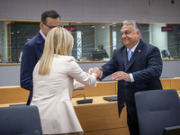 Prime Minister of Hungary Viktor Orban at the Tour de Table - Round Table seen kissing the hand of Giorgia Meloni PM of Italy next to Mateus...