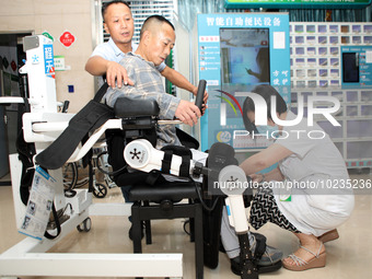 

Medical staff are fastening a patient to a lower limb rehabilitation robot in Chongqing, China, on July 4, 2023. (