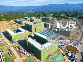 

An aerial photo shows the construction of the new schools of Yuexi Middle School in Anqing City, Anhui Province, China on July 5, 2023. (