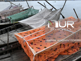 Boatmans sleep under a mosquito nets on their boats to protect them from dengue at the bank of the Buriganga River in Dhaka, Bangladesh, on...