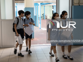Students holding their secondary school allocation result arriving at a school hall on July 11, 2023 in Hong Kong, China. Primary School Stu...