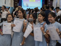 Students holding their secondary school allocation result posing for a photo at a school hall on July 11, 2023 in Hong Kong, China. Primary...