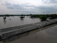 A general view of a low-lying area as it gets flooded with the rising water level of river Yamuna after heavy monsoon rains in New Delhi, In...