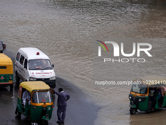 An ambulance gets stuck on the road as the carriageway gets flooded, after a rise in the water level of the river Yamuna due to heavy monsoo...