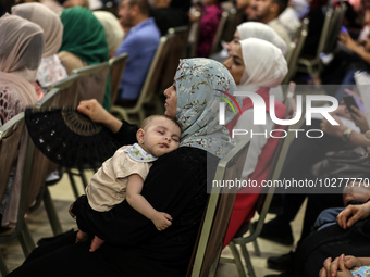 

Palestinians are watching young Palestinian choir members sing during a performance of the ''al-Sununu'' concert on July 18, 2023 in Gaza...