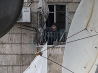 A man tied ropes curtains  on Bustan Alqasr district in Aleppo city on 1st February 2016.
(