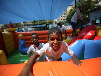 Palestinian children play during a four-week summer activities programme organised in 83 schools in the Gaza Strip by the United Nations Rel...
