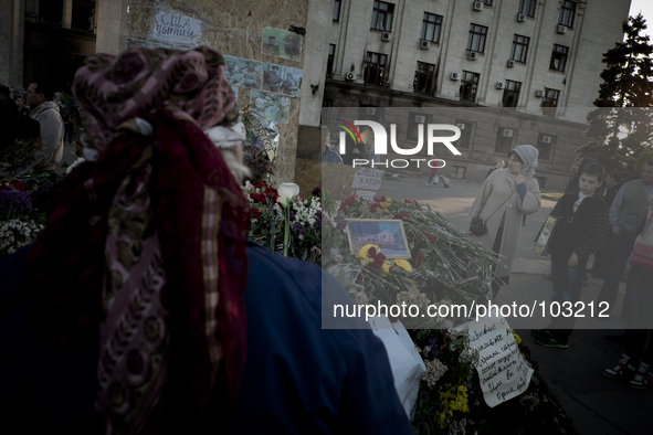 Women mourn in front of flowers outside the burnt trade union building in Odessa, Ukraine, Wednesday May 7, 2014. More than 40 people died i...