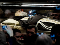 The box containing the corpse of Saint Pio da Pietralcina is carried inside St. Peter's Basilica at the Vatican, Friday, Feb. 5, 2016. (