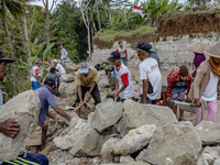 Villagers, including men and women, work together (gotong royong) to renovate a broken village road at Kebumen, Central Java, Indonesia on A...