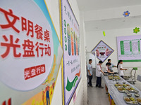 Students receive cutlery for lunch at Yanghe Primary School in Gaoliu town, Qingzhou city, East China's Shandong province, Sept 4, 2023. (