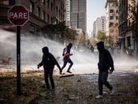 Thousands of Chilean students take out to the streets of Santiago de Chile to demand education reforms. At the end of the rally, groups of p...