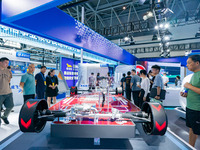  Citizens look at the architecture of new energy vehicles at the 2023 SMART CHINA EXPO in Chongqing, China, Sept. 5, 2023. (