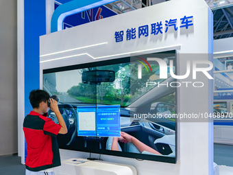  Citizens experience connected cars at the 2023 SMART CHINA EXPO in Chongqing, China, Sept. 5, 2023. (
