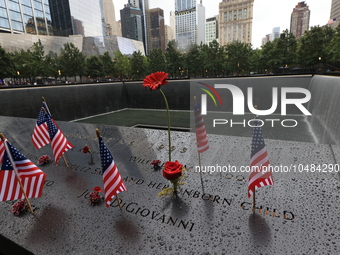 Flowers and US flags are laid on one of the North Pool panels at World Trade Center Memorial to commemorate the 9/11 Anniversary in New York...