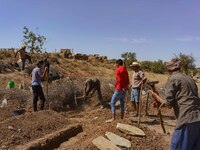 A group of men is digging graves for the earthquake victims in the village of Tafeghaghte. (