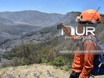 Some of  officer monitors hotspots on the slopes of a mountain that have been burning since mid-August during the dry season in the Bromo Te...