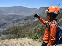 Some of  officer monitors hotspots on the slopes of a mountain that have been burning since mid-August during the dry season in the Bromo Te...