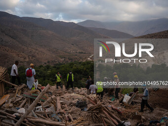 A foreign rescue ream probes debris of a cluster of houses in search of survivors and earthquake victims' bodies in the village of  Imi N'Ta...