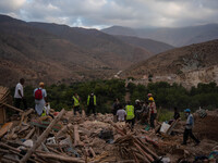 A foreign rescue ream probes debris of a cluster of houses in search of survivors and earthquake victims' bodies in the village of  Imi N'Ta...