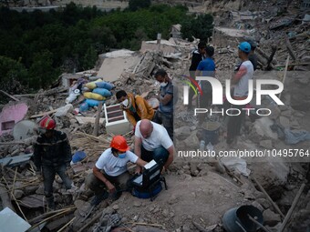 A foreign rescue team inspects the rubble of the houses destroyed by the earthquake in the village of Imi N'Tala, located 75 kilometers sout...