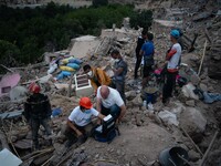 A foreign rescue team inspects the rubble of the houses destroyed by the earthquake in the village of Imi N'Tala, located 75 kilometers sout...