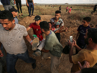 An injured Palestinian protestor is carried away following clashes with Israeli security forces along the Gaza-Israel border east of Gaza Ci...