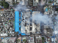 An aerial view shows smoke rises after a massive fire broke out, at the Mohammadpur Krishi Market in Dhaka, Bangladesh, on September 14, 202...