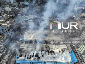 An aerial view shows smoke rises after a massive fire broke out, at the Mohammadpur Krishi Market in Dhaka, Bangladesh, on September 14, 202...