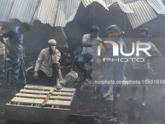 Shop owners gather in front of their shop after a massive fire broke out, at the Mohammadpur Krishi Market in Dhaka, Bangladesh, on Septembe...