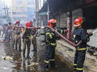Firefighters try to extinguish a fire that broke out, at the Mohammadpur Krishi Market in Dhaka, Bangladesh, on September 14, 2023.
 (