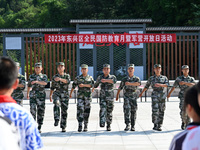 Children watch a Queue Demo at a new recruit training camp in Tianjia town, Neijiang city, Sichuan province, China, Sept. 15, 2023. Septembe...