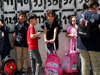 Children  wait in front of a school as the 2023-2024 academic year begins for Tunisian students after the summer holiday in Tunis, Tunisia o...