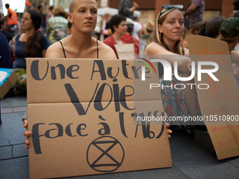 A young woman holds a placard reading 'Another way is possible against the A69'.Extinction Rebellion (XR) Toulouse organized a sit-in of wom...