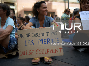 A woman holds a placard reading 'One can't dissolve Mothers who rise up'. Extinction Rebellion (XR) Toulouse organized a sit-in of women in...